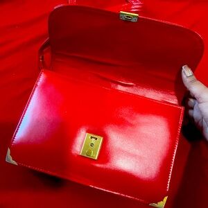 Red authentic leather shoulder purse with gold detailing.